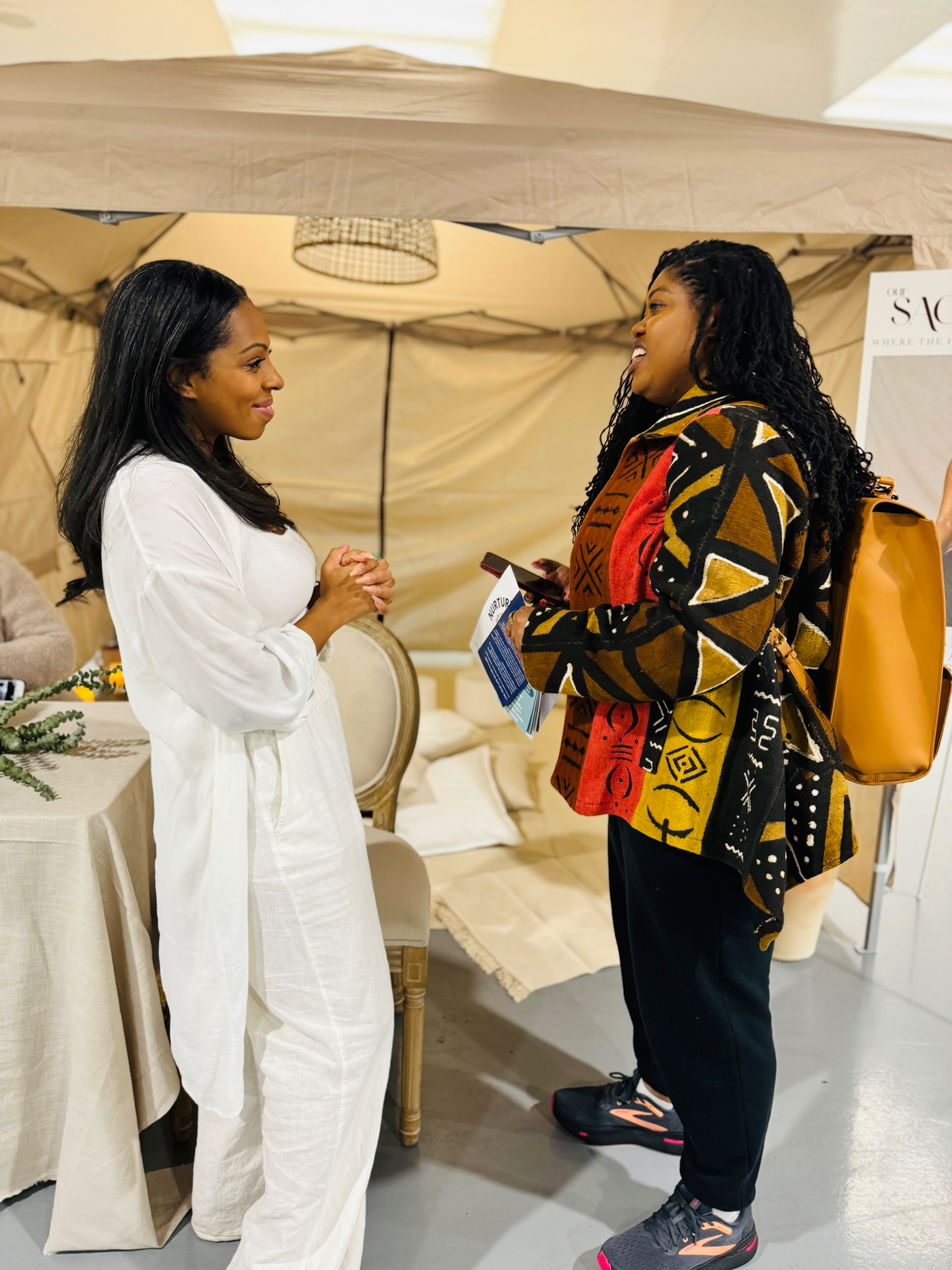 Two women connecting at a past VA Women's Expo vendor booth